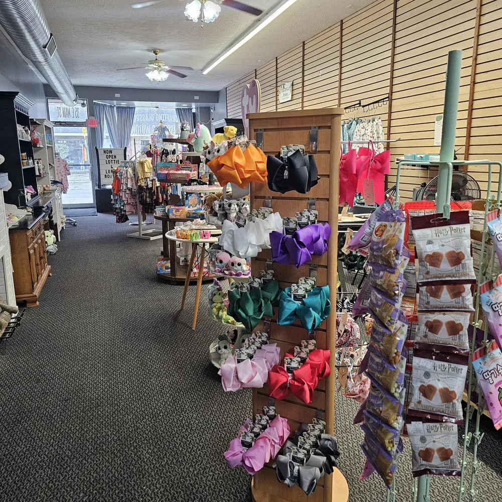 A rainbow of large hair bows displayed inside the boutique